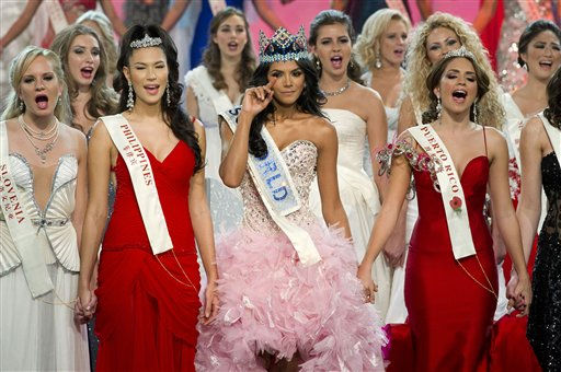 Miss Venezuela Ivian Sarcos, center, waves...