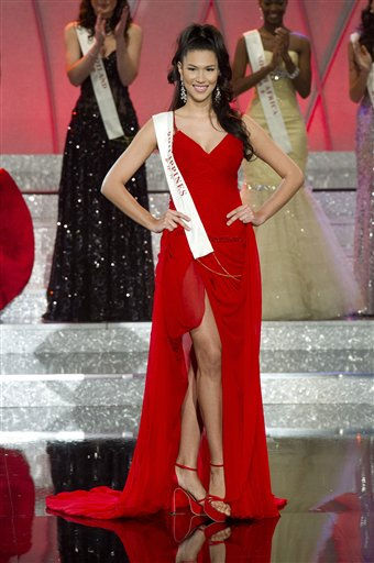 Miss Venezuela Ivian Sarcos, center, waves...