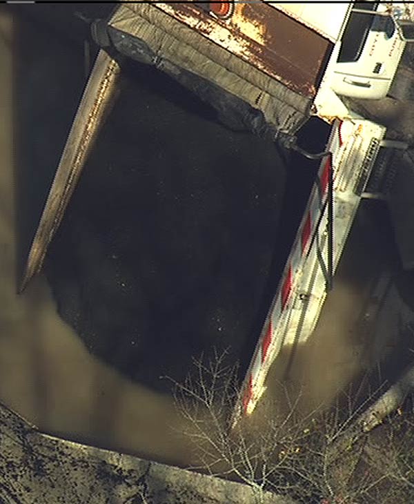 A dump truck loaded with gravel to repair...