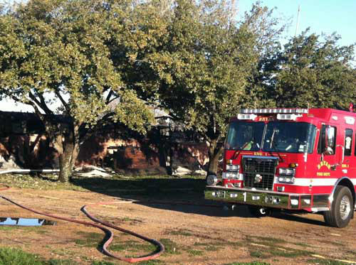 Galveston firefighters stand by in the hallways...