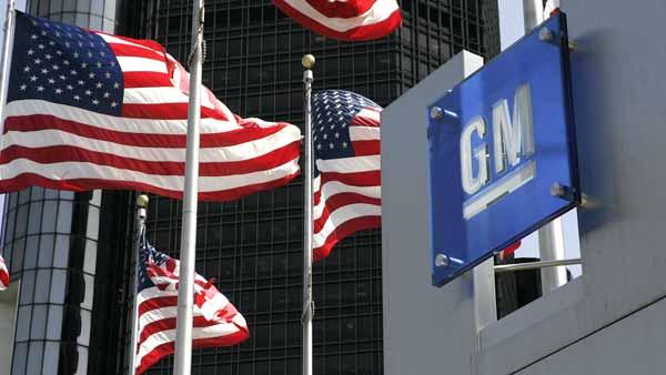 ** FILE ** U.S. flags are shown outside of General Motors world headquarters in a Detroit file photo from April 18, 2006. (AP Photo/Paul Sancya, File)