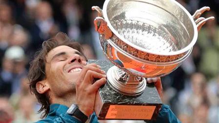 Spains Rafael Nadal lifts the cup after defeating compatriot David Ferrer during the mens final match of the French Open tennis tournament at the Roland Garros stadium Sunday, June 9, 2013 in Paris. (AP Photo/Michel Euler)