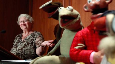 FILE- in this Wed., Aug. 25, 2010 photo, Jane Henson, left, donates some of Jim Hensons early puppets, including the original Kermit, to the Smithsonian Institution, during a ceremony at the National Museum of American History, in Washington.