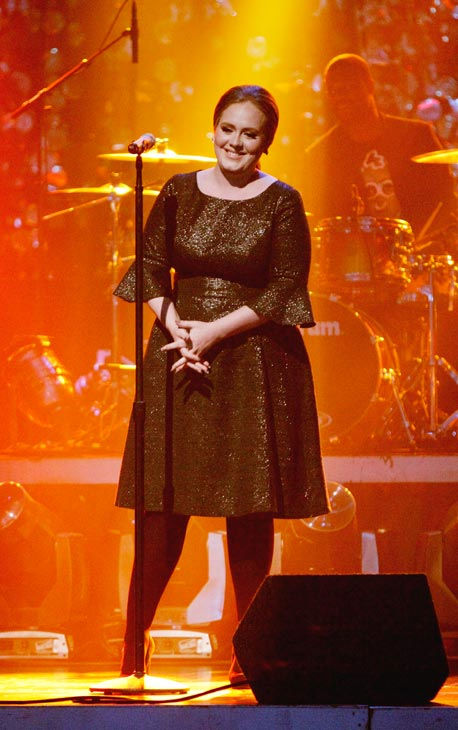 Adele takes the stage to sing her hit single...