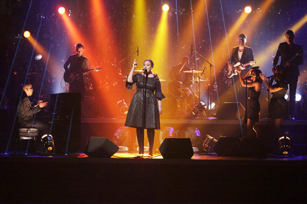 Adele takes the stage to sing her hit single...
