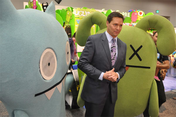 On The Red Carpet host Chris Balish poses with...