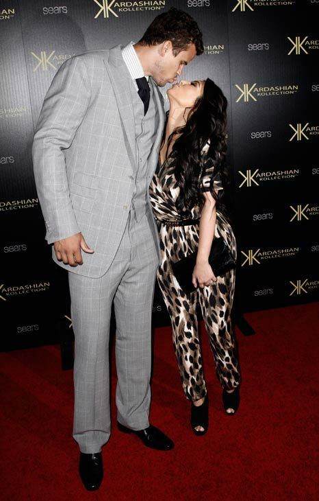 Kim Kardashian, right, and her fiance, NBA...