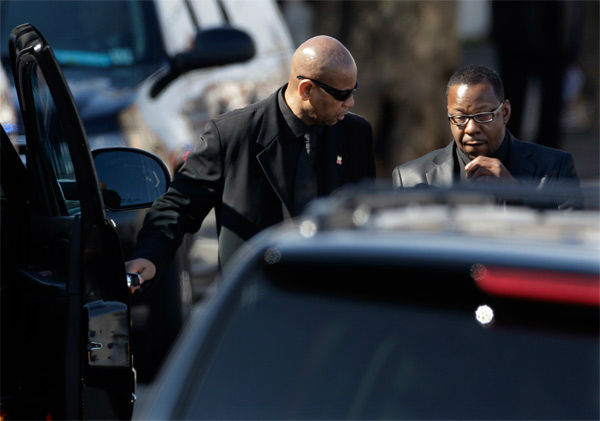 Singer Bobby Brown, right, is escorted to a...