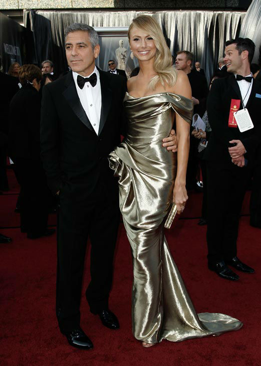 George Clooney and Stacy Keibler arrive before the 84th Academy Awards on Sunday, Feb. 26, 2012, in the Hollywood section of Los Angeles.