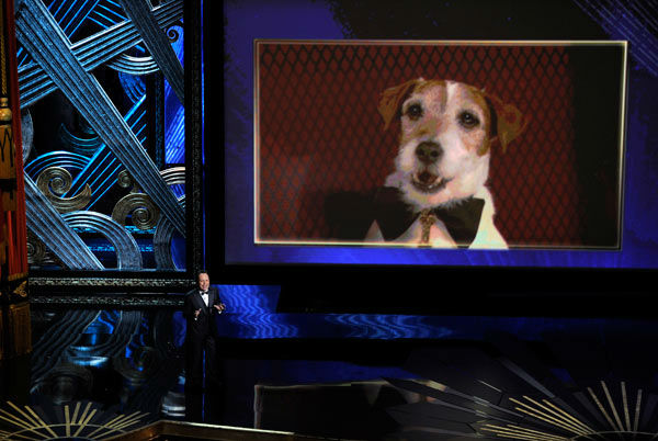 Billy Crystal talks about Uggie, seen  onscreen,...