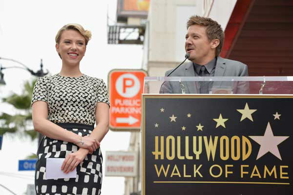 Actor Jeremy Renner (R) speaks while actress...
