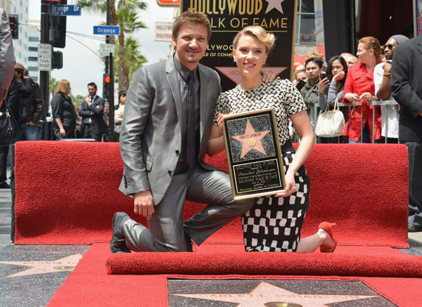 Actor Jeremy Renner (L) poses with actress...