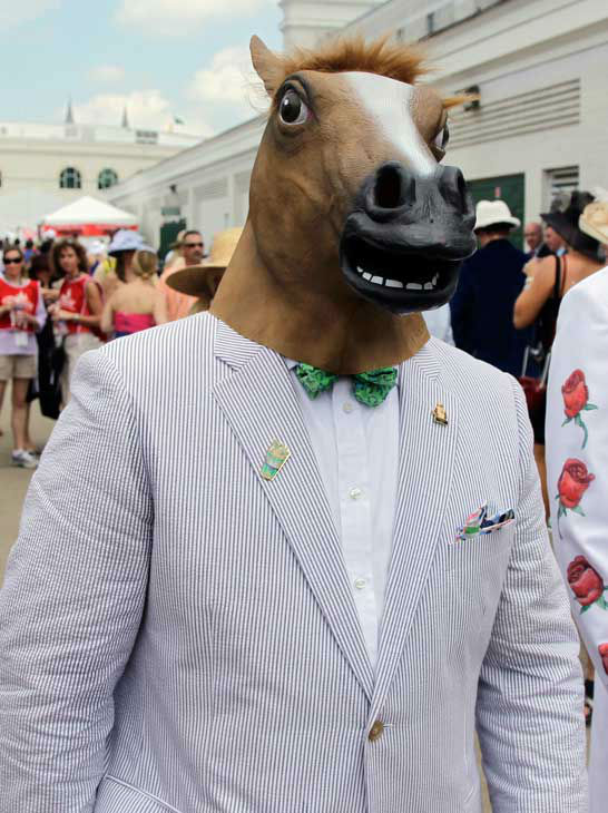 Gino Desimone arrives in a horse head mask for...