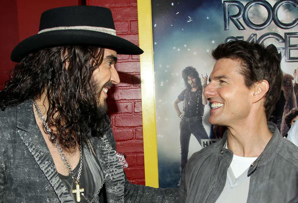 Russell Brand, left, and Tom Cruise arrive at...