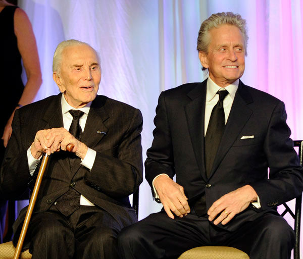 Actor Michael Douglas, right, introduces his...