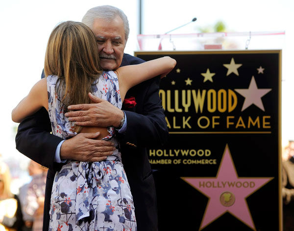 Actress Jennifer Aniston  is embraced by her...