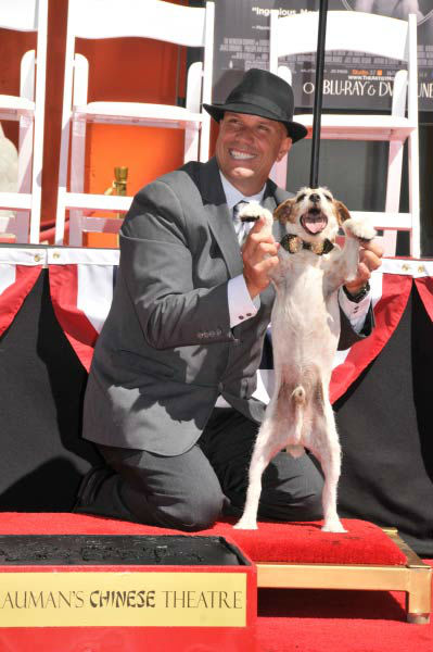 Uggie, the 10-year-old Jack Russell terrier who starred in 'The Artist,' was honored with a retirement party and a paw print ceremony at Grauman's Chinese Theatre on June 25, 2012. Uggie is seen with his trainer Omar Von Muller at the event. <br /><br />'
