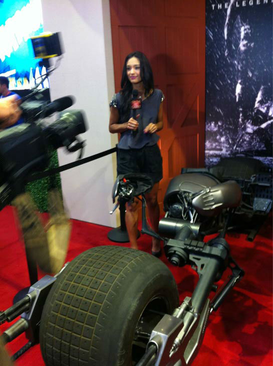 OnTheRedCarpet.com host Rachel Smith appears in a photo with the Batpod from 'The Dark Knight Rises' at San Diego Comic-Con on Wednesday, July 11, 2012.