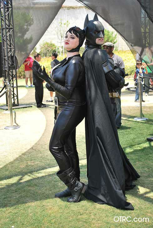 Fans dressed as Catwoman and Batman appear in a...
