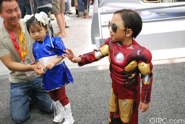 A young fan dressed as Iron Man and one dressed...