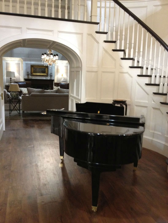Pictured is a winding staircase and piano inside...