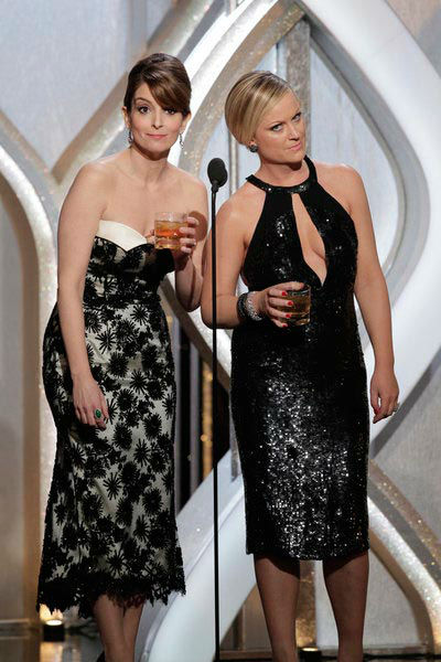 Hosts Tina Fey, Amy Poehler on stage during the...