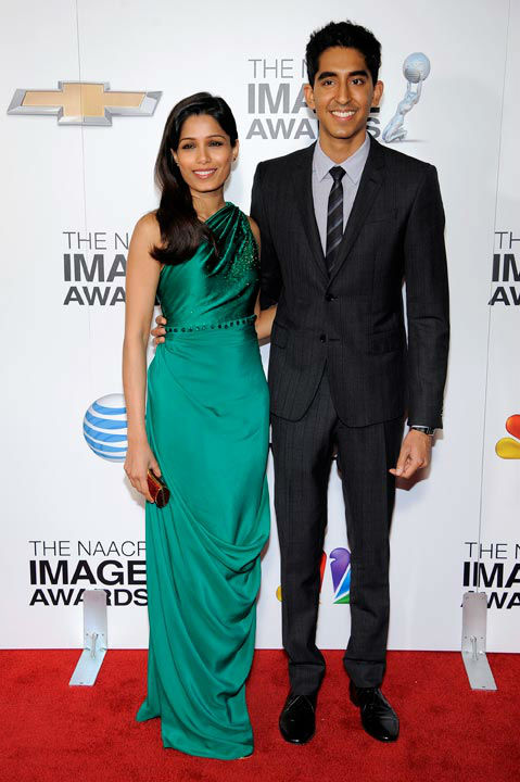 Freida Pinto, left, and Dev Patel arrive at the...