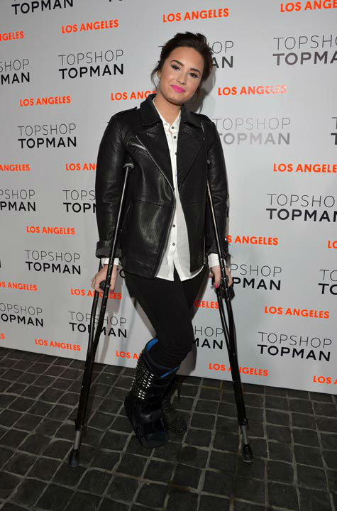 Actress/singer Demi Lovato arrives wearing Topshop at the Topshop Topman LA Opening Party at Cecconi's West Hollywood on February 13, 2013 in Los Angeles, California.