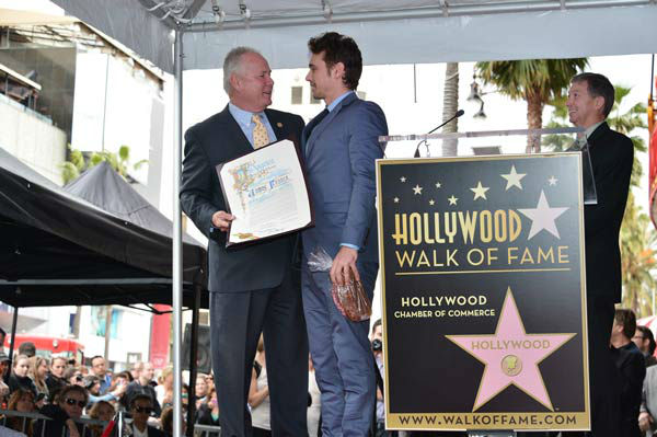 Actor James Franco (R) and Councilmember Tom...