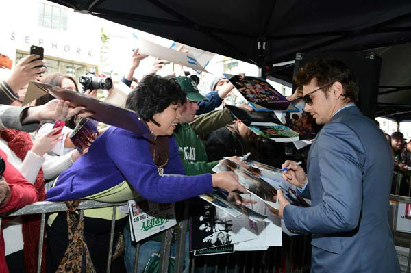 Actor James Franco signs autographs after a...