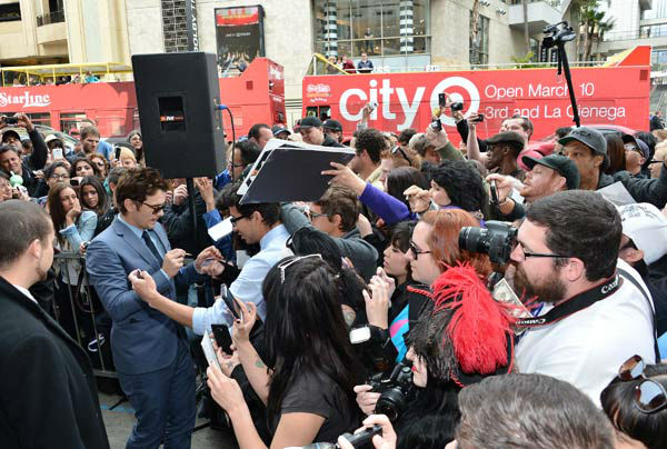 Actor James Franco signs autographs after a...