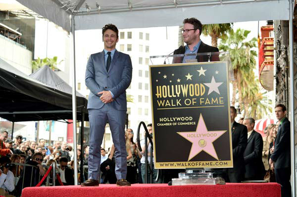 Actors James Franco (L) and Seth Rogen speak...