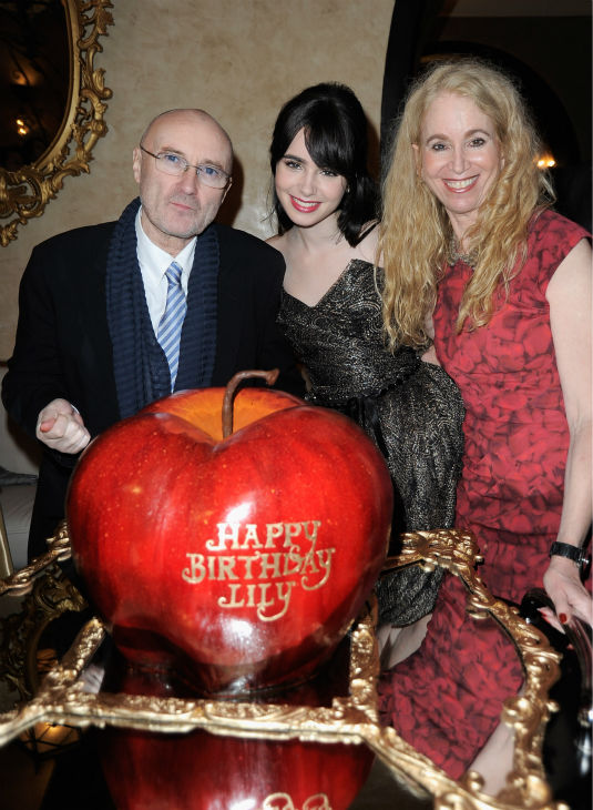 Musician Phil Collins, his daughter Lily Collins and Jill Tavelman  arrive at the premiere of 'Mirror Mirror' at the Grauman's Chinese Theatre on March 17, 2012 in Hollywood, California.
