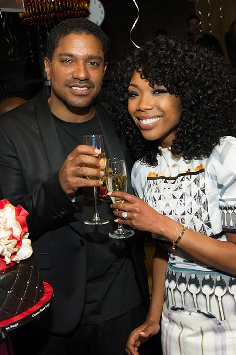Brandy and fiance Ryan Press toast to 2013 at a...
