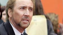 Alice Kim and Nicolas Cage at the ceremony where movie and television producer Jerry Bruckheimer added his hand and footprints in the forecourt of Graumans Chinese Theatre in the Hollywood district of Los Angeles Monday, May 17, 2010. - Provided courtesy of AP / AP Photo/Reed Saxon
