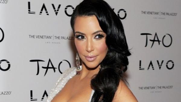 Kim Kardashian poses at Tao nighclub at the Venetian hotel in Las Vegas ahead of her New Year's Eve party on Dec. 31, 2010. She is wearing a Marc Bower dress, Tres Glam jewelry and Christian Louboutin heels.