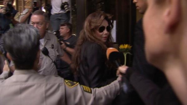 Holding a sunflower given her by a fan, Michael Jackson's sister Latoya Jackson arrives at the involuntary manslaughter trial for Dr. Conrad Murray on Tuesday, Sept. 27, 2011.