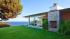 Brad Pitt appears in a still from the 2011 film, Tree of Life. / Brad Pitts Malibu beach house appears in an undated photo. - Provided courtesy of Summit Entertainment / Fox Searchlight Pictures / Realtor.com