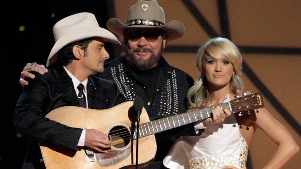 Host Brad Paisley, left, Hank Williams Jr., center, and hostess Carrie Underwood speak during the 45th Annual CMA Awards in Nashville, Tenn., on Wednesday, Nov. 9, 2011. - Provided courtesy of AP / Mark Humphrey Host Brad Paisley, left, Hank Williams Jr., center, and hostess Carrie Underwood speak during the 45th Annual CMA Awards in Nashville, Tenn., on Wednesday, Nov. 9, 2011. - Provided courtesy of AP / Mark Humphrey