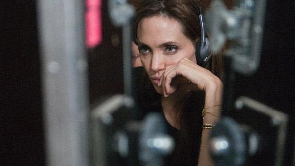 Angelina Jolie appears behind the camera as she makes her directorial debut with the 2011 film 'In The Land of Blood and Honey.'