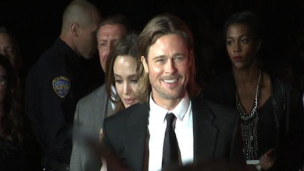 Brad Pitt stands in front of Angelina Jolie at the Palm Springs International Film Festival on Jan. 7, 2012.