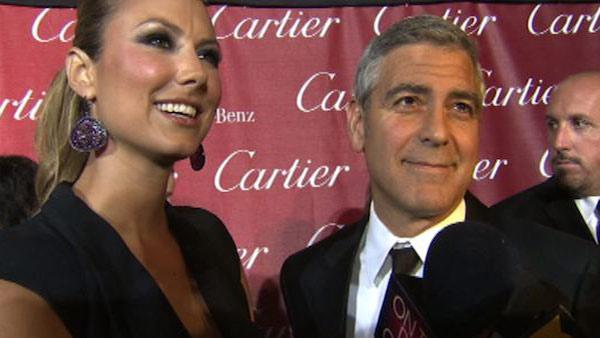 George Clooney talks to OnTheRedCarpet.com at the Palm Springs International Film Festival on Jan. 7, 2012. Pictured on the left is his girlfriend, former WWE star Stacy Keibler. - Provided courtesy of OTRC