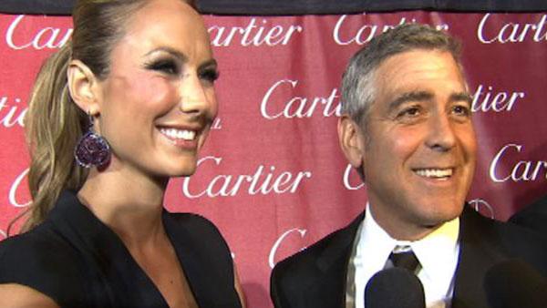 George Clooney talks to OnTheRedCarpet.com at the Palm Springs International Film Festival on Jan. 7, 2012. Pictured on the left is his girlfriend, former WWE star Stacy Keibler.