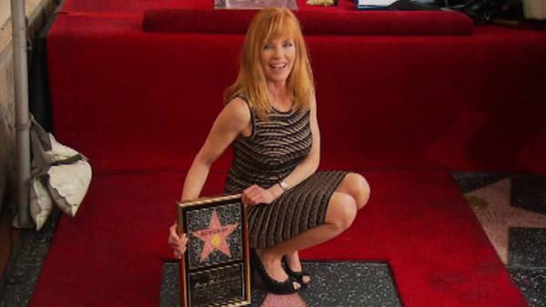 Marg Helgenberger of 'CSI: Crime Scene Investigation' poses on her star on the Hollywood Walk of Fame on Jan. 23, 2012.