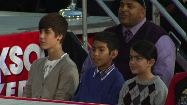Justin Bieber (left) watches performers on stage at Michael Jackson's hand and footprint ceremony at the Grauman's Chinese Theatre on Jan. 26, 2012, after shaking his son Prince's hand.