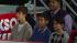 Justin Bieber (left) watches performers on stage...