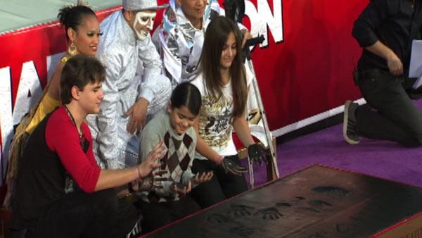 Michael Jackson's children Prince (left), Blanket (middle) and Paris place their hands in cement along an imprint of their father's sequined globe and dance shoes at a ceremony at the Grauman's Chinese Theatre on Jan. 26, 2012.