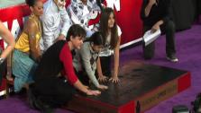 Michael Jacksons children Prince (left), Blanket (middle) and Paris place their hands in cement along an imprint of their fathers sequined globe and dance shoes at a ceremony at the Graumans Chinese Theatre on Jan. 26, 2012. - Provided courtesy of OTRC