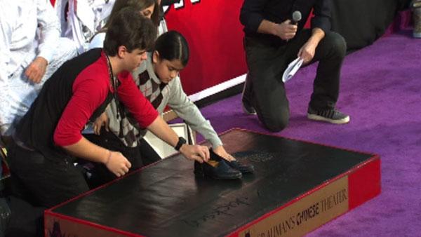 Prince and Blanket Jackson place their late father Michael Jackson's dance shoes in cement at the King of Pop's hand and footprint ceremony at the Grauman's Chinese Theatre on Jan. 26, 2012.