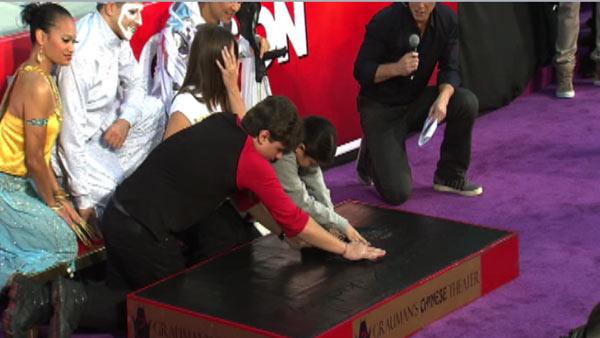Prince and Blanket Jackson place their late father Michael Jackson's dance shoes in cement at the King of Pop's hand and footprint ceremony at the Grauman's Chinese Theatre on Jan. 26, 2012.
